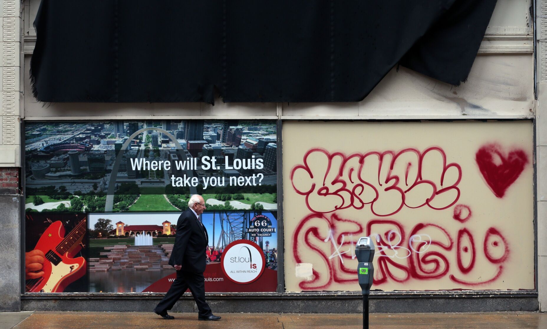 Grafitti and regional advertising adorn the Railway Exchange windows in March 2022 as St. Louis population dips below 300,000